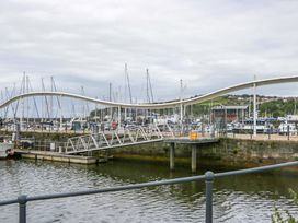 A marina with boats and a bridge at Duncan Square in Whitehaven