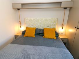 A bedroom with a bed and pillows at No 13 Broadfield Farm Holiday Park, Saundersfoot