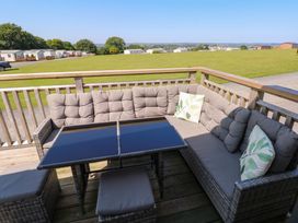 A seating area with a sofa and table at No 13 Broadfield Farm Holiday Park in Saundersfoot