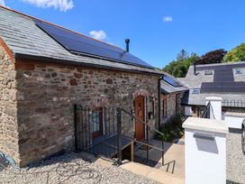 An outdoor view of a cottage with solar panels at Hedgehog Highway in Parkham