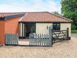 An entrance with a gate and pathway at The Kiln in Mendham near Harleston