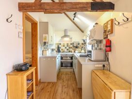 A kitchen with appliances and wooden furniture at The Kiln in Mendham near Harleston