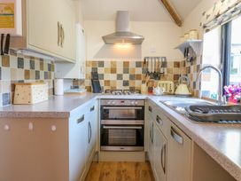 A kitchen with cabinets and appliances at The Kiln in Mendham near Harleston