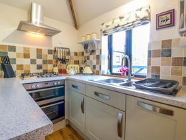 A kitchen with a sink and stove at The Kiln in Mendham near Harleston