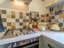 A kitchen with a stovetop, kettle and toaster at The Kiln in Mendham near Harleston