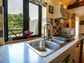 A kitchen with a sink and window at The Kiln Mendham near Harleston