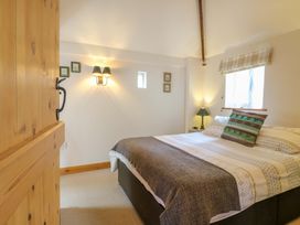 A bedroom with a bed and lamps at The Kiln in Mendham near Harleston
