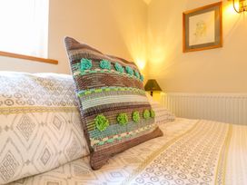 A bedroom with a pillow and lamp at The Kiln in Mendham near Harleston