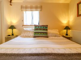A bedroom with a bed and side tables at The Kiln in Mendham near Harleston