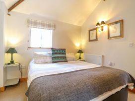 A bedroom with a bed and bedside table at The Kiln in Mendham near Harleston