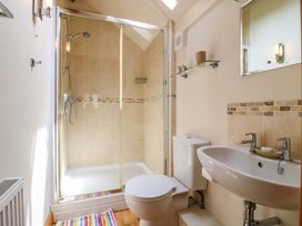 A bathroom with a shower, toilet, and sink at The Kiln in Mendham near Harleston