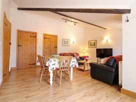 A living room with a dining table and sofa at The Golden Cross Mendham near Harleston