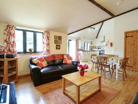 A living room with a sofa and coffee table at The Golden Cross in Mendham near Harleston