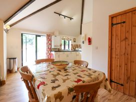 A kitchen with a table and chairs at The Golden Cross in Mendham near Harleston