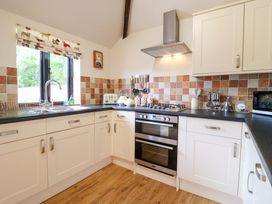 A kitchen with appliances and a window at The Golden Cross in Mendham near Harleston