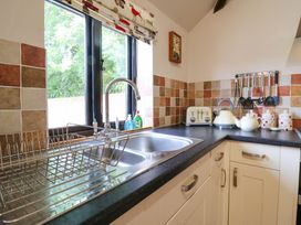 A kitchen with a sink and appliances at The Golden Cross in Mendham near Harleston