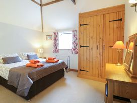 A bedroom with a bed and wardrobe at The Golden Cross in Mendham near Harleston