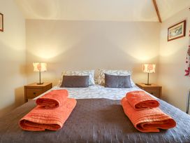 A bedroom with a bed and bedside tables at The Golden Cross Mendham near Harleston