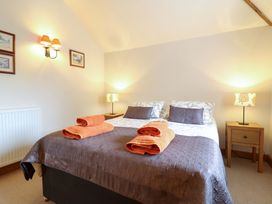 A bedroom with a bed and towels at The Golden Cross Mendham near Harleston