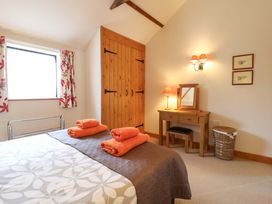 A bedroom with a bed and a desk at The Golden Cross in Mendham near Harleston
