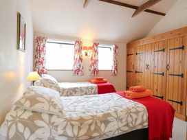 A bedroom with two beds and a window at The Golden Cross in Mendham near Harleston