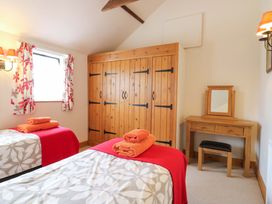 A bedroom with two beds and a wardrobe at The Golden Cross Mendham near Harleston