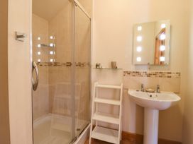 A bathroom with a shower and sink at The Golden Cross in Mendham near Harleston