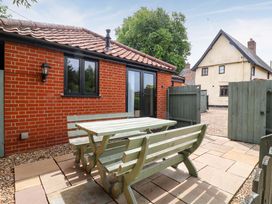 An outdoor area with a table and chairs at The Golden Cross in Mendham near Harleston
