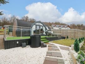 An outdoor area with a cabin and seating at Crofters Suite 