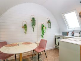 A kitchen with a table and two chairs at Crofters Suite in 