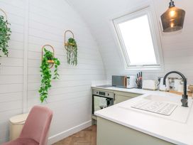 A kitchen with a sink and microwave at Crofters Suite