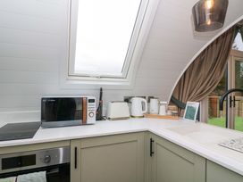 A kitchen with a microwave and kettle at Crofters Suite