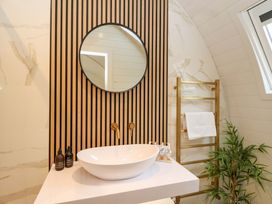 A bathroom with a sink and a mirror at Crofters Suite