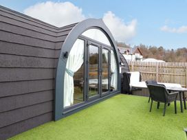 An outdoor area with a window and seating at Crofters Suite