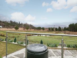 A view of a grassy area with a pond in Crofters Suite