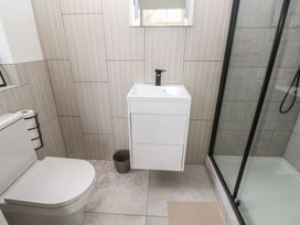 A bathroom with a sink, toilet, and shower at Ty Landsker in Milford Haven