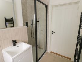 A bathroom featuring a sink, shower, and towel rail at Ty Landsker in Milford Haven
