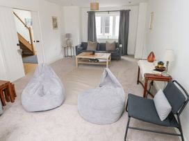 A living room with bean bags and a sofa at Ty Landsker Houghton near Neyland