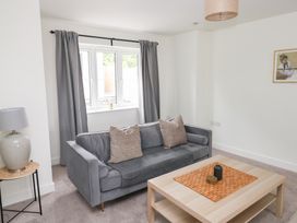 A living room with a sofa and coffee table at Ty Landsker in Houghton near Neyland