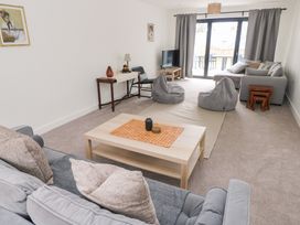 A living room with sofas and a coffee table at Ty Landsker in Houghton near Neyland