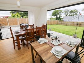 A dining room with tables and chairs at Ty Landsker in Houghton near Neyland