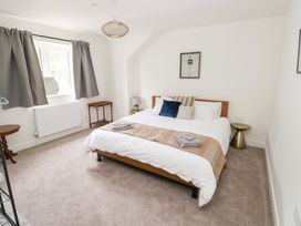 A bedroom with a bed and side tables at Ty Landsker in Houghton near Neyland