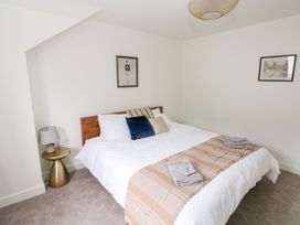 A bedroom with a double bed and side table at Ty Landsker in Houghton near Neyland
