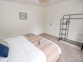 A bedroom with a bed and towel on the side at Ty Landsker in Houghton near Neyland