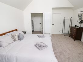 A bedroom with a bed and dresser at Ty Landsker in Houghton near Neyland
