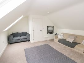 A living room with a sofa and chair at Ty Landsker in Houghton near Neyland