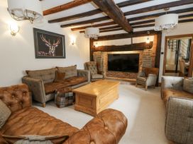 A living room with a coffee table and a television at Stud Farm House in Bleddfa near Knighton
