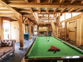 A game room with a pool table and a staircase at Stud Farm House Bleddfa near Knighton