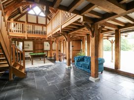 A living room with a snooker table and staircase at Stud Farm House Bleddfa near Knighton