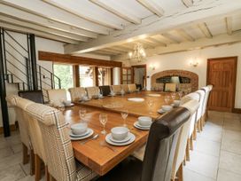 A dining room with a large table set for meals at Stud Farm House Bleddfa near Knighton